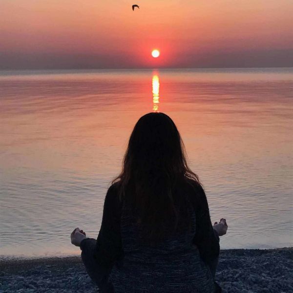 Allison meditating at sunset